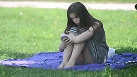 Sitting on the grass displaying her goodies